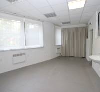 Spacious commercial premises with windows, a sink, and a curtain.