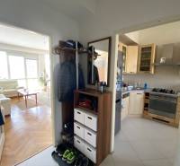Spacious hallway with entrance to the kitchen and living room in a 4-room apartment.