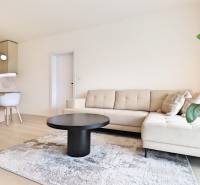 Living room in a 3-room apartment with a sofa, coffee table, and dining area.