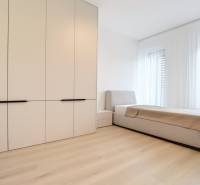 A bedroom with a built-in wardrobe and bed in a 3-room apartment, bright and spacious.