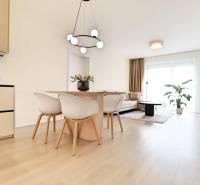 Dining room with living room, bright interior, wooden floors, 3-room apartment, minimalist design.