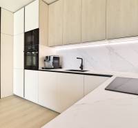 A kitchen in a 3-room apartment with marble tiles and built-in appliances.