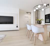 A stylish living room with a TV, dining table, and modern kitchen in a 3-room apartment.