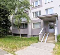 An apartment building surrounded by greenery with an access path in Košice IV, near a 3-room apartment.