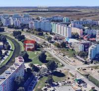 Aerial view of residential blocks on Strečnianska Street in Bratislava V with a pond.