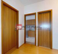 A hallway with light doors in a 3-room apartment.