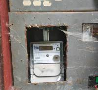 An old electrical panel with a spider web inside the cabin.