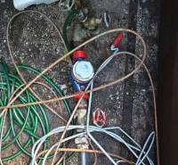 Water shut-off with a tangle of hoses in the cottage's boiler room.