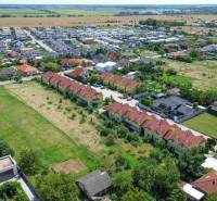 Aerial view of a residential area and development plots on Slnečná Street in Miloslavov.