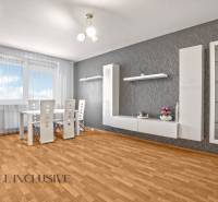 Dining area with a white table and chairs in a 2-room apartment.