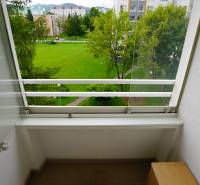 A balcony with a view of greenery and objects in Nova Dubnica, ideal for a 2-room apartment.