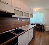 A kitchen unit with a dining table in a 2-room apartment.
