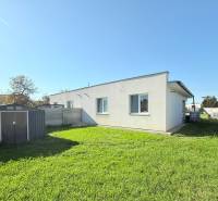 A family house in Košúty with a lawn and a garden shed in the yard.