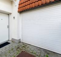 The entrance door and garage driveway of the Family house on Hattalova Street in Bratislava - Nové Mesto.