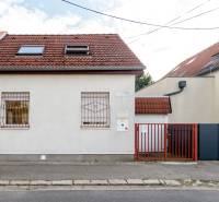 A family house on Hattalova Street in Bratislava - Nové Mesto with a red roof and fence.