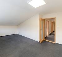 Spacious room with carpet and glass doors in a family house.