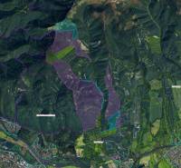 Aerial view of agricultural and forest lands around Sučany, showing different zones of use.