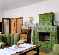 Living room with green tiles and retro furniture in a family house.