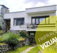 A family house in Plavecký Mikuláš surrounded by a well-maintained garden and flowers.