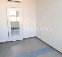 Office with air conditioning, doors, and a window with a radiator.