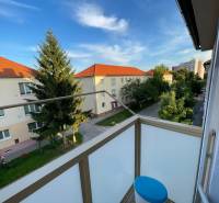 The balcony of a 2-room apartment on Hurbanova Street in Skalica with a view of trees and buildings.