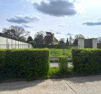 Plots - housing in Sládkovičovo, behind the green fence there is a spacious meadow.