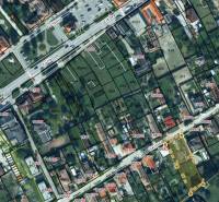 An aerial map shows Školská Street with a focus on residential plots.