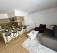 Living room in a 3-room apartment with a kitchen, bar counter, and corner sofa.