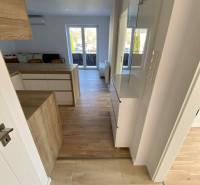 Bright interior of a 3-room apartment with wooden flooring and access to a terrace.