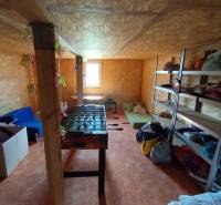 A room with wooden walls, a foosball table, shelves, and a window. Property - living.