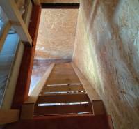 A staircase with wooden elements in a space suitable for plots - living.