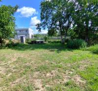 Residential plots surrounded by greenery in Jelšovce with proximity to family houses.