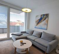 A comfortable living room with a corner sofa and art in a two-room apartment.