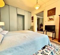 A bedroom in a 2-room apartment with a double bed and antique furniture.