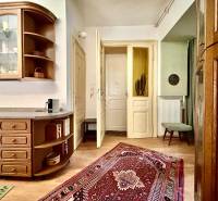 A kitchen corner with wooden furniture in a 2-room apartment, decorated with an oriental rug.