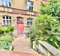 A historical building on Flöglova Street in Bratislava - Old Town, surrounded by greenery.
