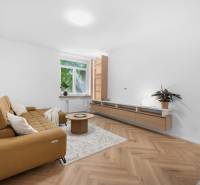 Living room in a 3-room apartment with a sofa, coffee table, and wooden floor.