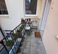 Balcony on Ventúrska in Bratislava at a 2-room apartment with plants and chairs.