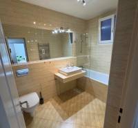 Bathroom in a 2-room apartment with a sink, bathtub, and toilet.