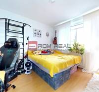 A room in a 3-room apartment with light furniture, a bed, and a desk.