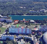 A view of Dragon Lake from Strečnianska Street with surrounding apartment buildings in Bratislava V.