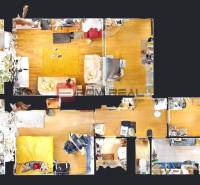 Floor plan of a 3-room apartment with wooden floors, rooms, and a balcony with plants.