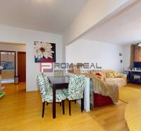 Living room in a 3-room apartment with a dining table, sofa, and desk.