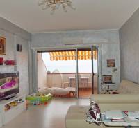 Living room in a 3-room apartment with a terrace, television, and comfortable sofas.