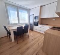 Kitchen in a 2-room apartment with a dining table, stove, and appliances.