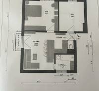 Floor plan of a 3-room apartment with a kitchen and a balcony, efficient use of space.