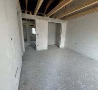 The interior of a family house with unfinished ceilings and incomplete walls.