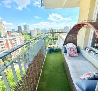 A balcony with artificial grass and garden furniture in a 2-room apartment with a view of Bratislava.