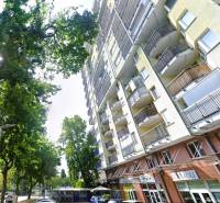 Apartment building with balconies on Jégého Street, Bratislava - Ružinov, surrounded by greenery.