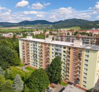 View of the apartment building with greenery in Nová Dubnica on SNP Street.